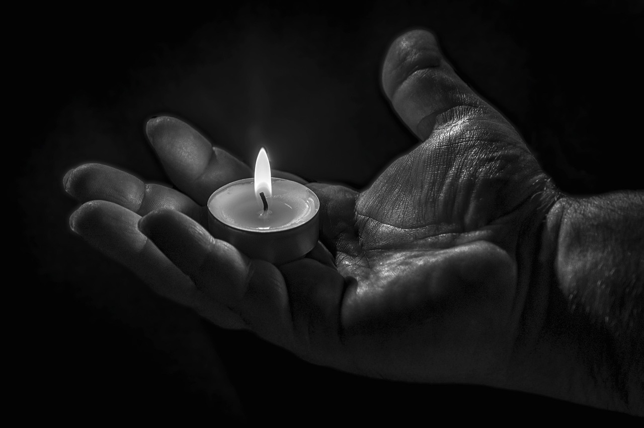 hands pouring soy wax candle